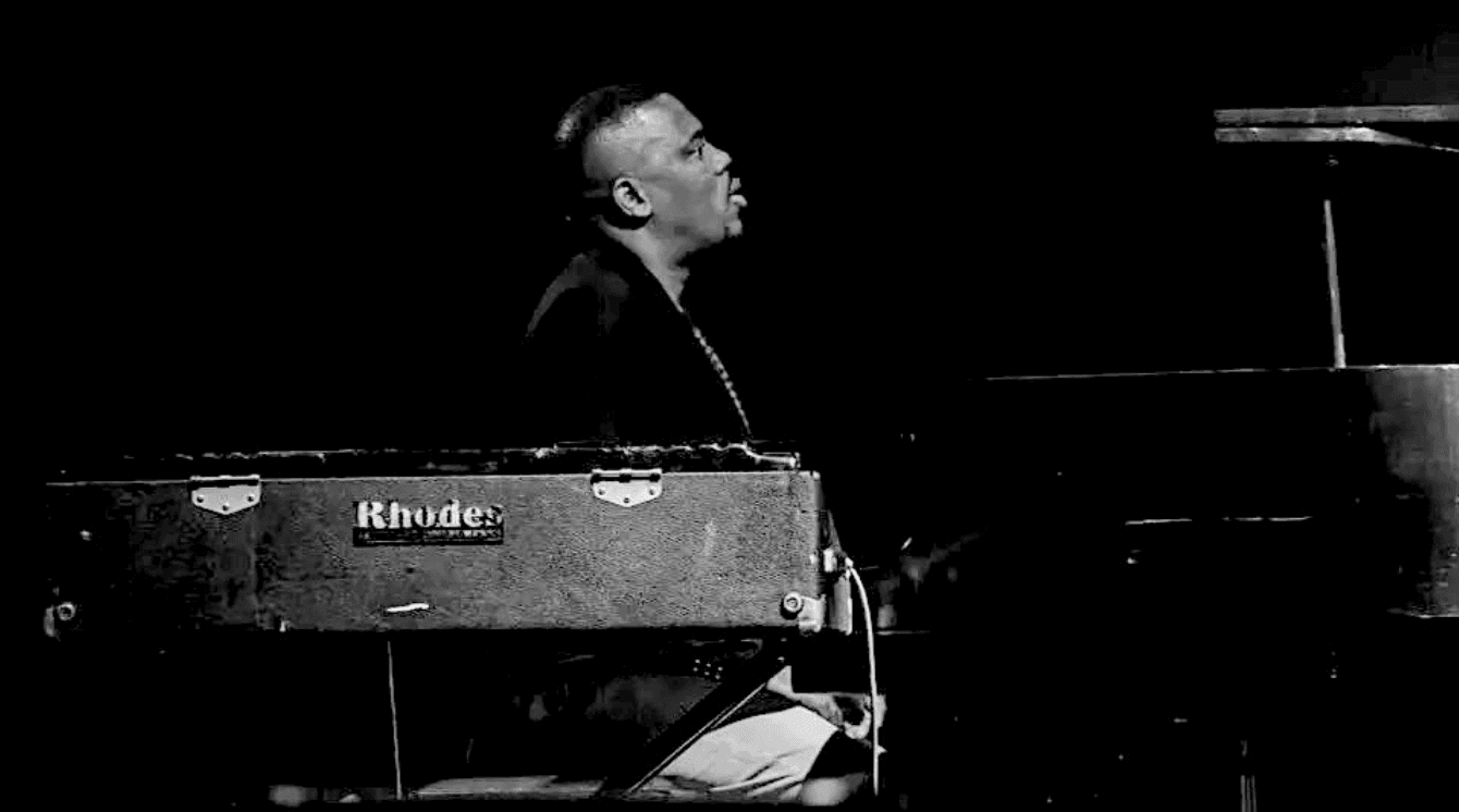 Luyanda Madope playing keys on a dark stage